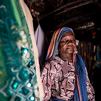 A woman standing in her home. Links to Gifts by Will